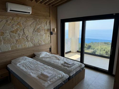 a bedroom with a bed and a large window at villa efraim read the details from the host for approval in Athens