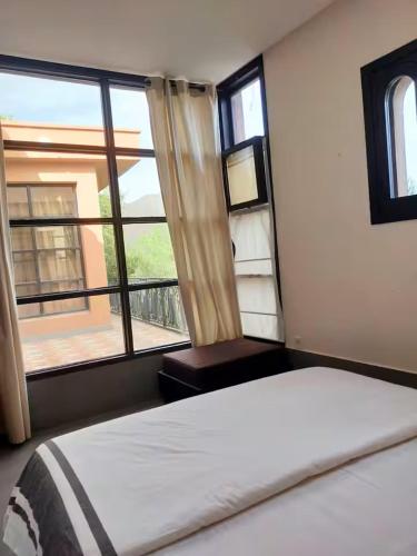 a bedroom with a bed and a large window at La Maison Nature , Mountains View Suite in Ourika