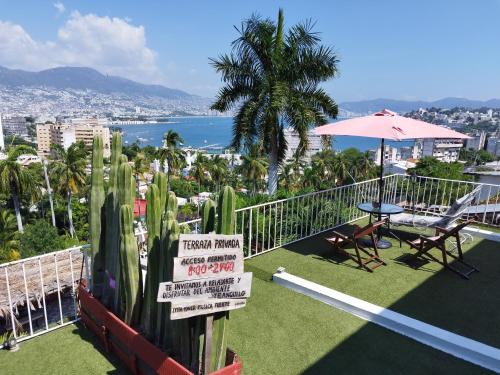 a balcony of a hotel with a view of the ocean at Casa Breizh - Adult Only in Acapulco
