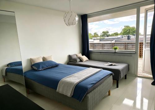 a bedroom with two beds and a window at Villan Lyan in Lund