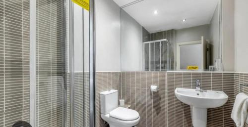 a bathroom with a toilet and a sink at The Fairways Pub in Templebrough