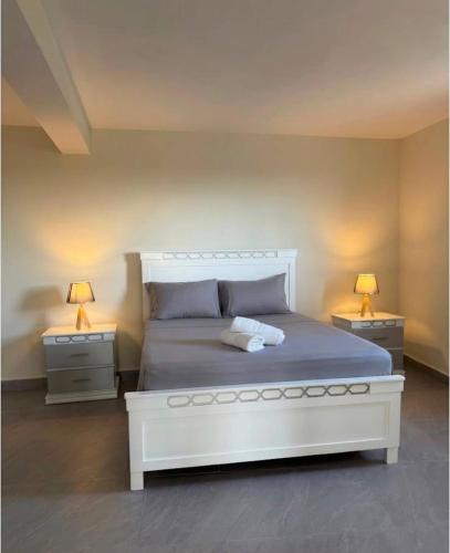 a bedroom with a large white bed with two night stands at Rico Puerto magic spot east in Cabrera