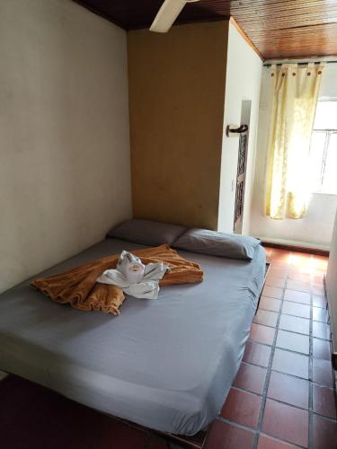 a bed in a room with a blanket on it at Hotel Cacique in Socorro