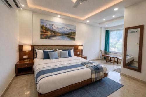 a bedroom with a large bed and a large window at Sitara Premium Dhakad Gold, Near Lakshman Jhula, Tapovan in Rishīkesh