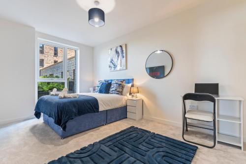 a bedroom with a bed and a mirror and a chair at 2 Bed Flat, Pool Table, Terrace 4 stops to Wembley in Hatch End