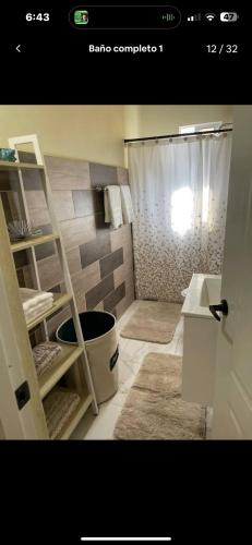 a bathroom with a shower and a sink at Rico Puerto Village cabrera in Cabrera