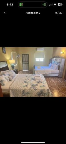 a bedroom with two beds and a couch at Rico Puerto Village cabrera in Cabrera