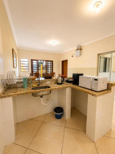 a kitchen with a counter with a microwave on it at Aura de Cunha in Cunha