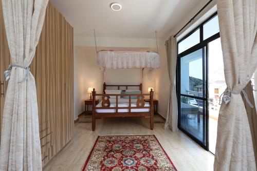 a room with a bed and a large window at Diani Luxe Villa 1bdr A, 600m from the beach in Galu