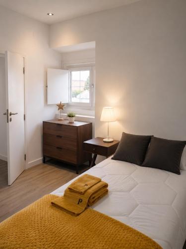 a bedroom with a bed with a robe on it at Casinha do Pão Bolorento in Évora