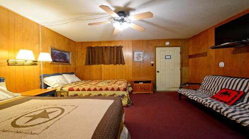 a hotel room with two beds and a ceiling fan at Arrowhead 18 in Red River