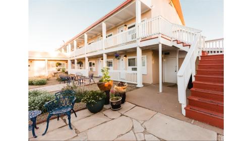 a large house with a patio with chairs and stairs at St James A9 in Cimarron