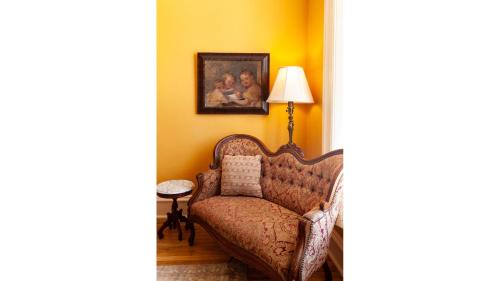 a living room with a chair and a portrait of two girls at Mary Lambert in Cimarron