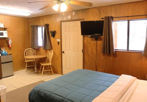 a bedroom with a bed and a tv and a table at Arrowhead 02 in Red River