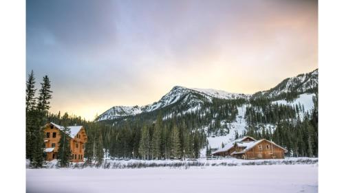 a group of buildings in the snow with mountains at Bavarian Chalet 1 in Taos Ski Valley