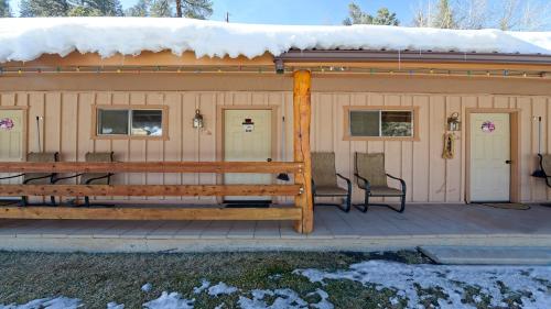 a house with a deck with a bench on it at Arrowhead 17 in Red River
