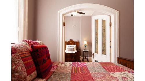 a bedroom with a bed and a mirror at Bat Masterson in Cimarron