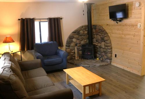 a living room with a couch and a fireplace at Arrowhead 01 Townhouse in Red River