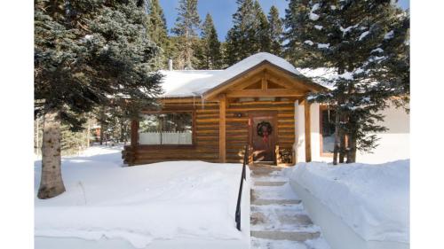 a log cabin in the snow at Denton Cabin in Taos Ski Valley