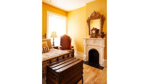 a living room with a fireplace and a mirror at Pancho Griego in Cimarron