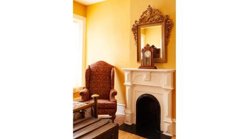 a living room with a fireplace and a mirror at Pancho Griego in Cimarron