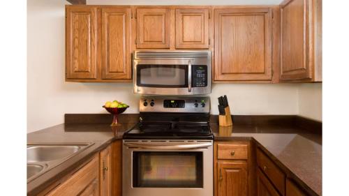 a kitchen with a microwave above a stove at Twining 7 in Taos Ski Valley