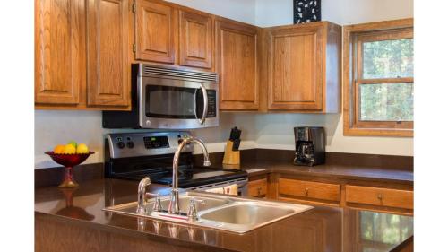 a kitchen with a sink and a microwave at Twining 7 in Taos Ski Valley