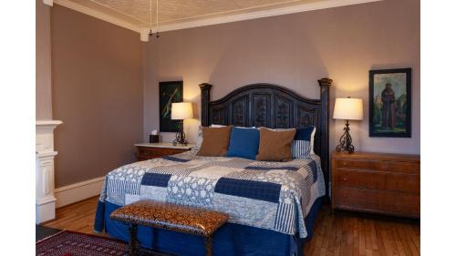 a bedroom with a blue and white bed and two lamps at Waite Phillips in Cimarron