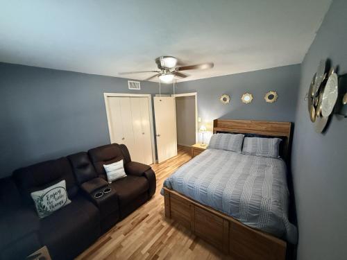 a bedroom with a bed and a couch at The Loft in McKinney