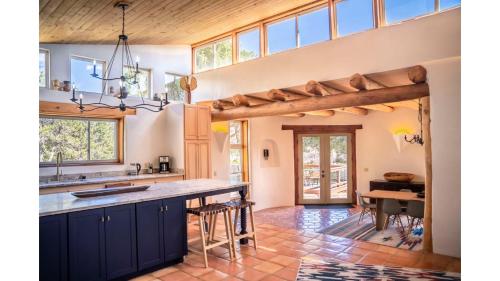 an open kitchen with blue cabinets and a vaulted ceiling at Casa Angel in Valdez