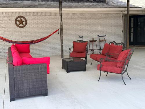 a group of chairs and tables with red cushions at The Loft in McKinney