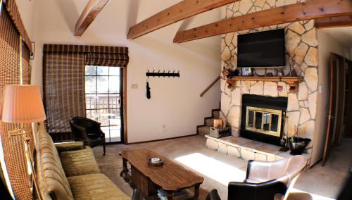 a living room with a fireplace and a tv at A Frame of Mind in Red River