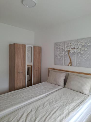 a bedroom with a large bed with white sheets at The Olive Branch in Sarajevo