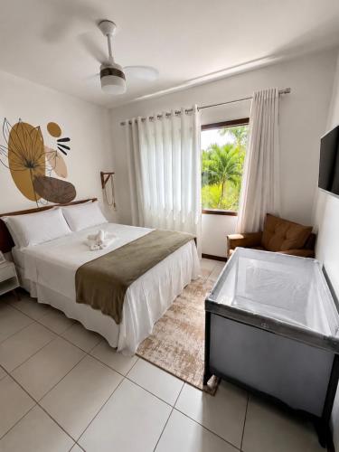 a bedroom with a bed and a tub in it at Flat Sol do Ipanema in Itacaré