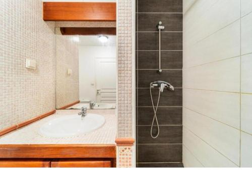 a bathroom with a sink and a shower at Le Saphir in Saint-Denis