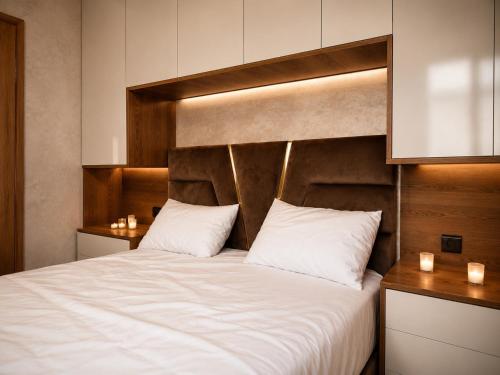a bedroom with a large bed with white sheets at Modern and Cozy in Agadir