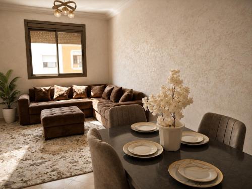 a living room with a table and a couch at Modern and Cozy in Agadir