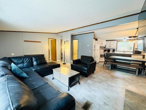 a living room with a leather couch and a piano at Put-in-Bay Island Club #71 in Put-in-Bay