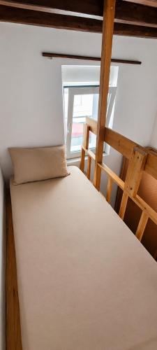 a bed in a room next to a window at Traditional House in Laerma in Láerma