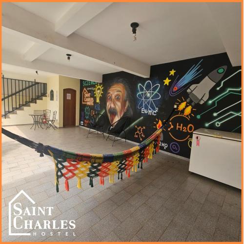 a room with a large painting on the wall at Saint Charles Hostel in São Carlos