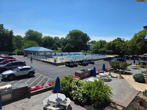 a parking lot with parked cars and blue umbrellas at Put-in-Bay Poolview Condo #4 in Put-in-Bay