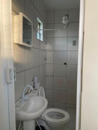 a small bathroom with a sink and a toilet at Pousada BR 423 in Garanhuns
