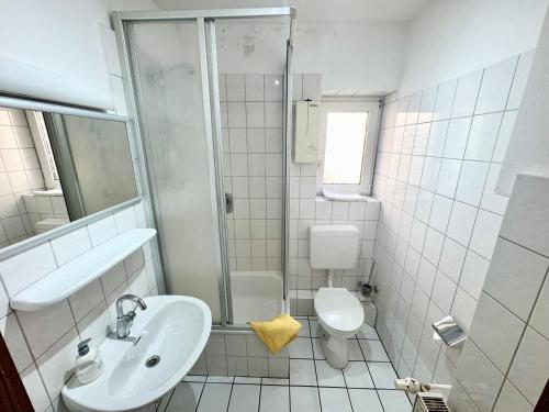 a bathroom with a sink and a toilet and a shower at Hotel Bauernstube in Oberhausen