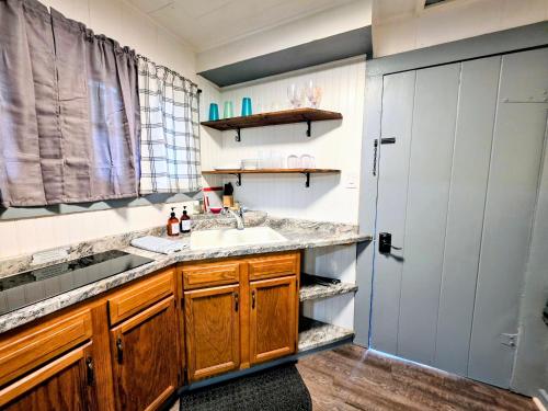 a kitchen with a sink and a counter at Edgewater Resort Cottage #1 in Hot Springs