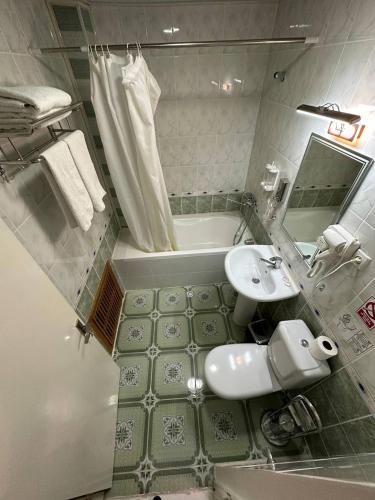 a bathroom with a sink and a bath tub at Orom Hotel & Terrace in Bukhara