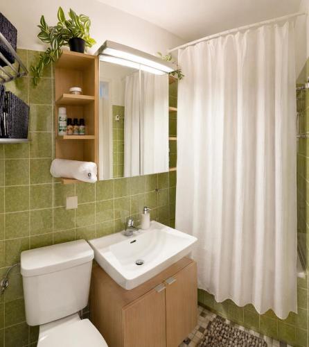 a bathroom with a white toilet and a sink at Wald Living in Baiersbronn