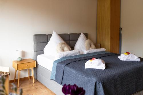 a bedroom with a bed with towels on it at Wald Living in Baiersbronn