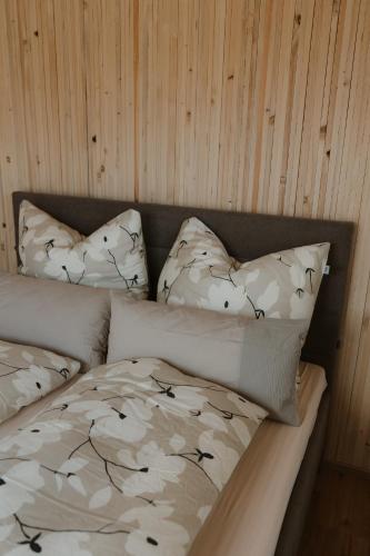 a bed with two pillows on top of it at Natururlaub by Klotz TINY HAUS a in Überlingen