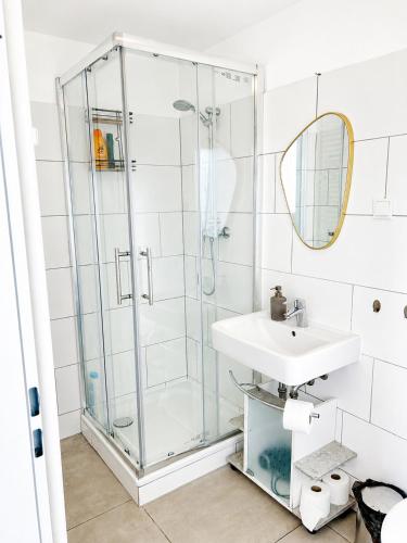 a bathroom with a shower and a sink at Freedom Studio Apartment in Berlin