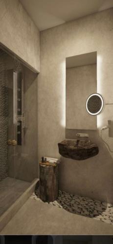 a bathroom with a sink and a glass shower at Casa Rico in Tulcea